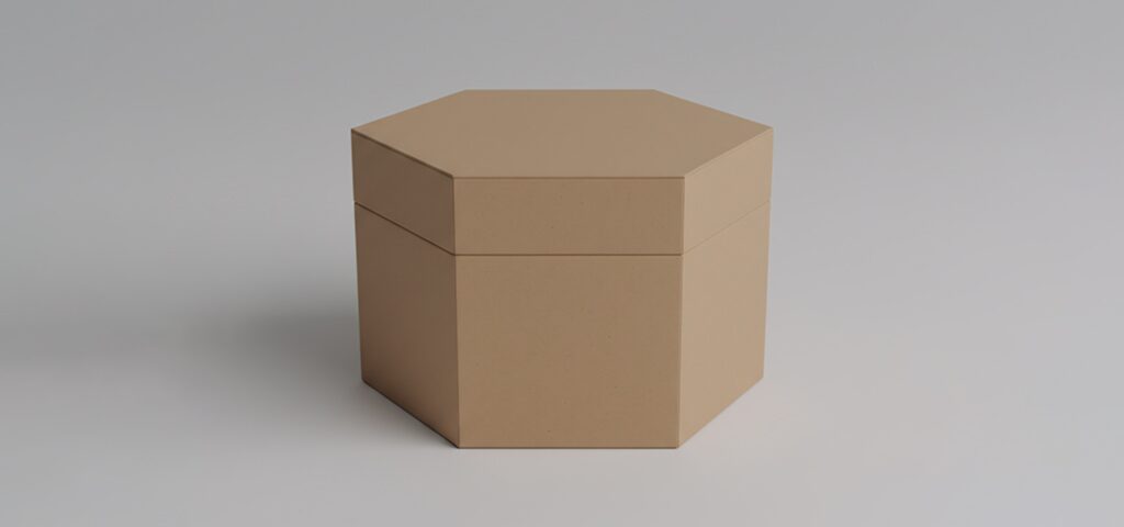 Plain hexagonal cardboard box with lid placed against a neutral background.